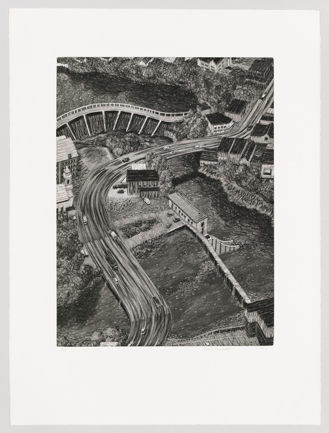 Aerial view of a winding road and bridge curving through a riverside village with small buildings.