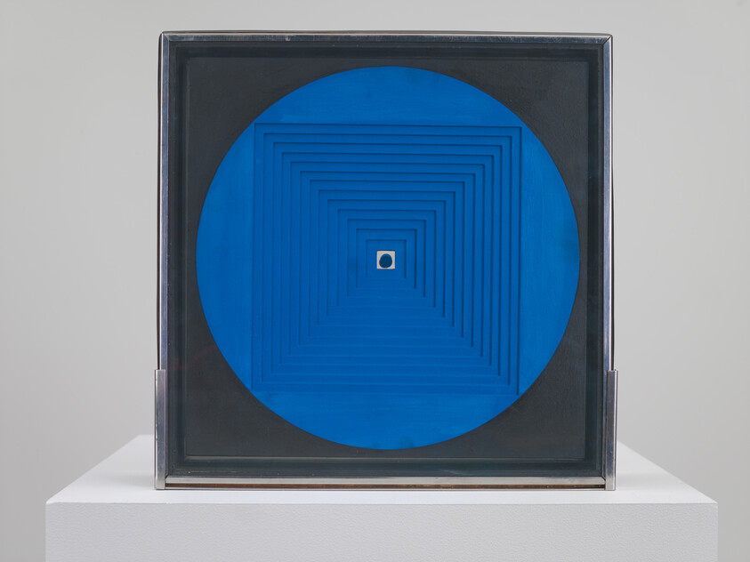A framed geometric artwork with a large blue circle and concentric square layers leading to a small central dot.