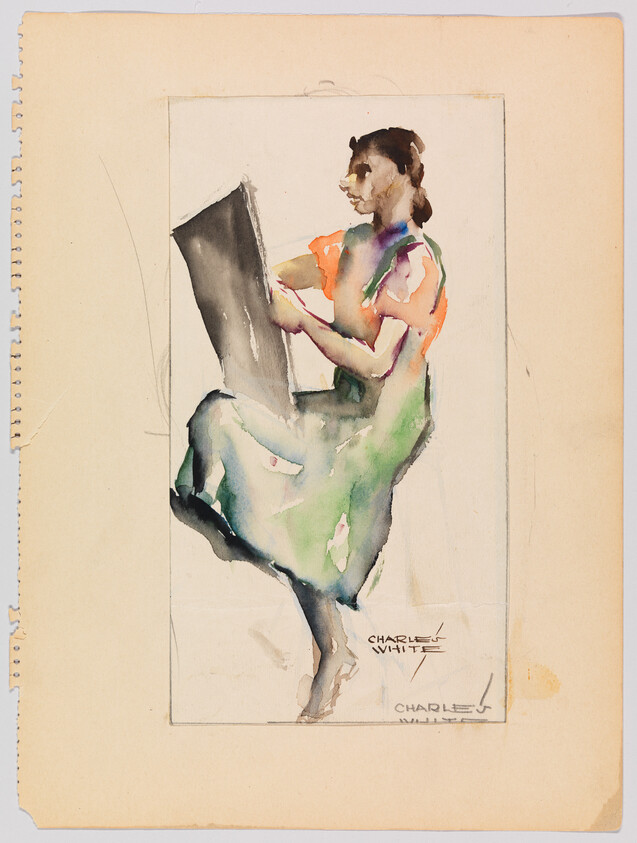 Woman in a green dress seated holding a large book or sketchpad.