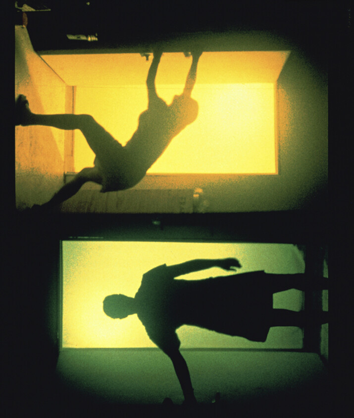 Two silhouetted figures appear in stacked glowing doorways, one hanging above and one standing below.