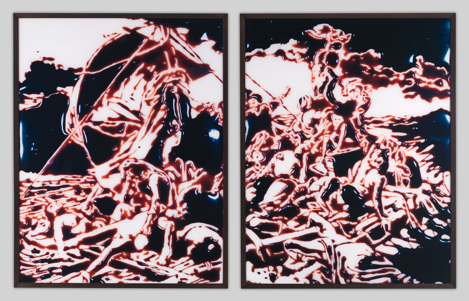 Two framed abstract panels showing red-outlined figures piled and struggling against a dark background.