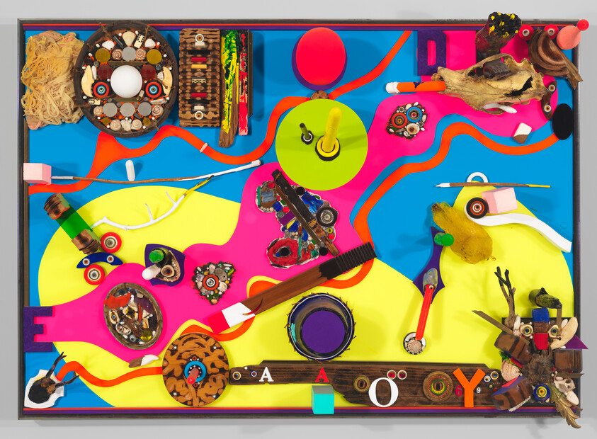 Colorful mixed-media collage with found objects arranged over wavy blue, pink, and yellow background.