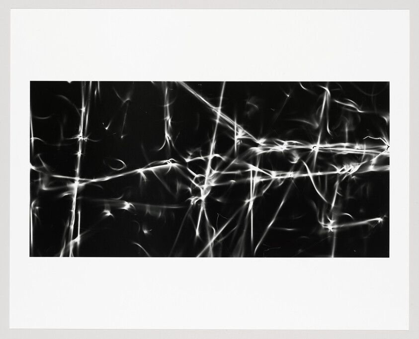 Abstract black rectangle with intersecting white light streaks forming a glowing, web-like grid.