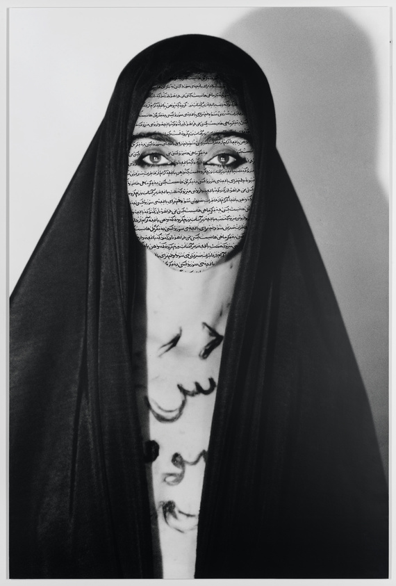 An Iranian woman in an open, vertical black veil with Farsi text covering her face. 
