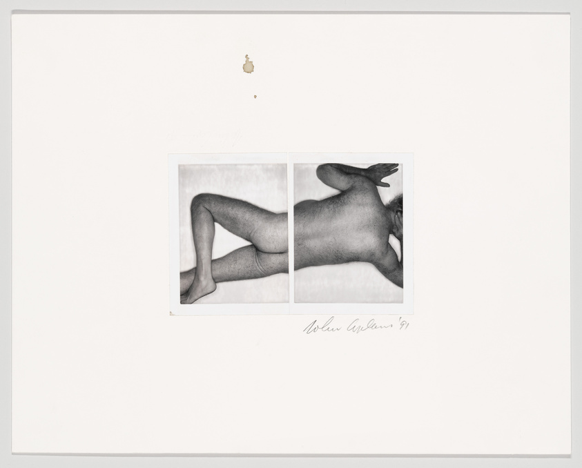 A nude body lays on stomach, legs crossed, arms at head.