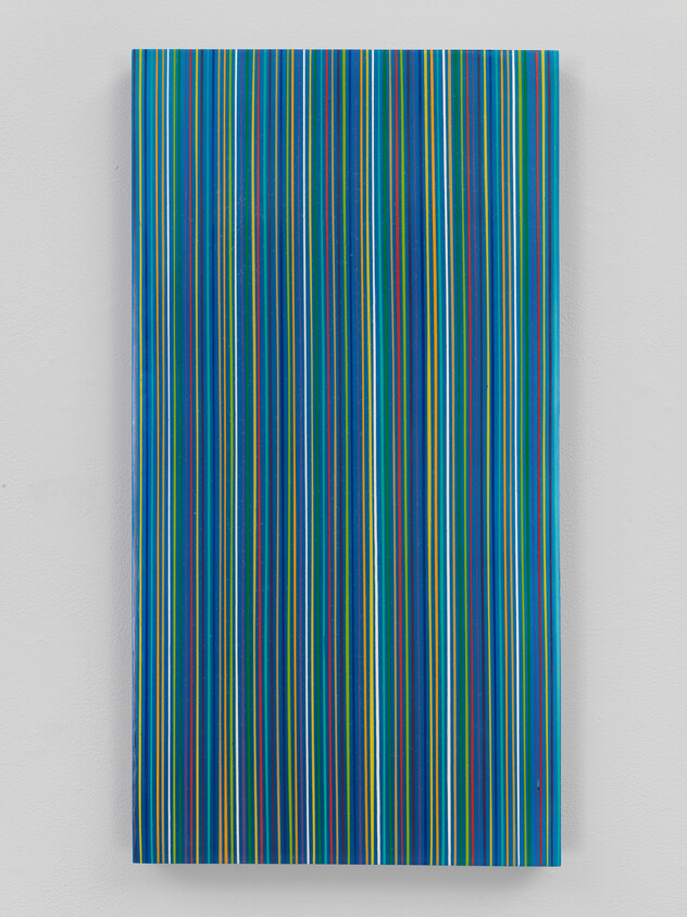 Tall rectangular panel covered in closely spaced vertical blue, green, and yellow stripes.