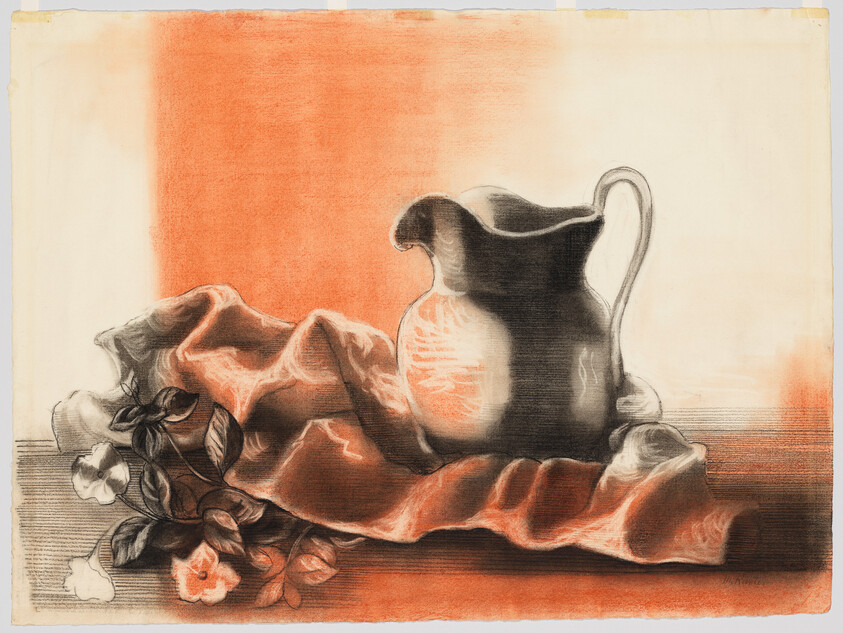 A ceramic pitcher sits on a draped cloth beside small blooming flowers on a table.