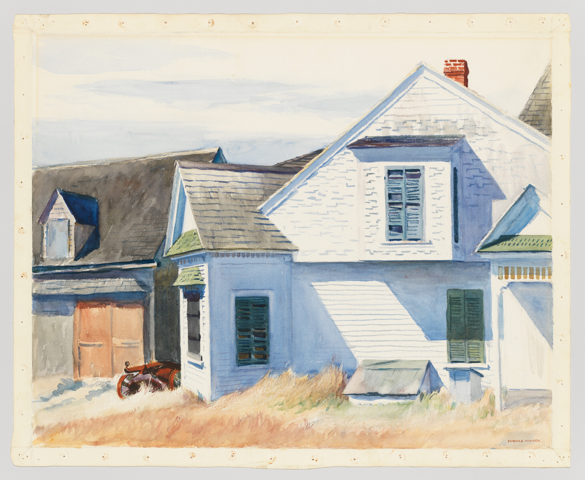 A sunlit white clapboard house with green shutters, shadows on the siding, and tall dry grass.