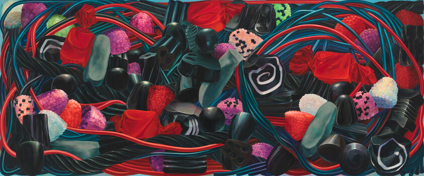A colorful assortment of licorice ropes, gummies, and wrapped candies tangled together.
