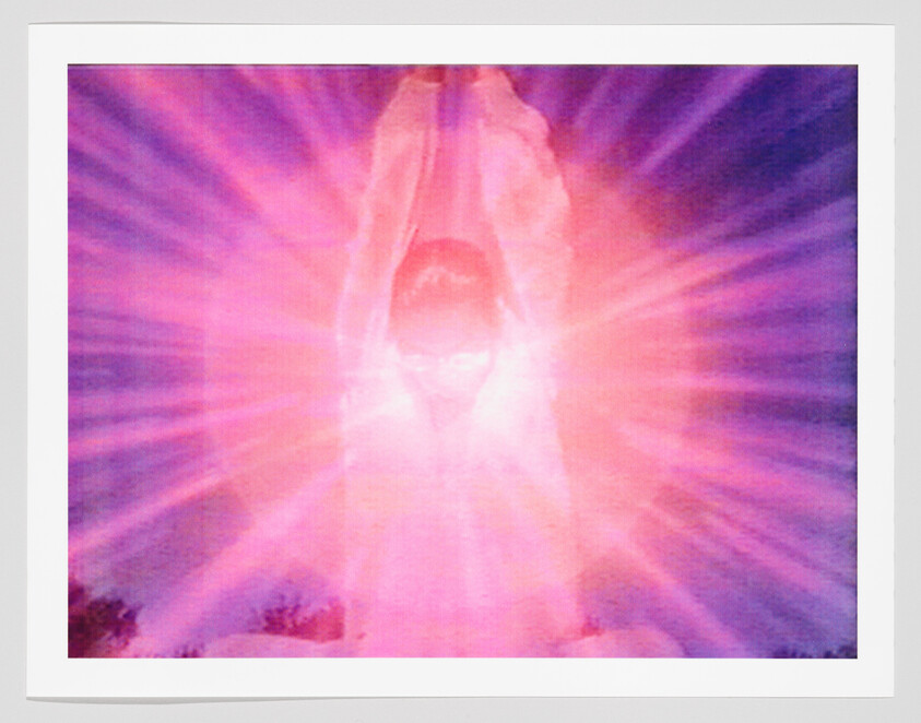 Person standing with arms raised surrounded by bright pink and purple radiating light.
