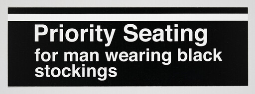 Priority seating is designated for a man wearing black stockings.