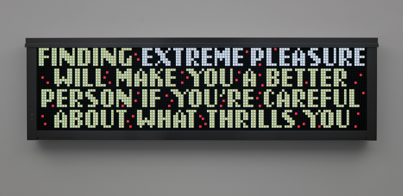 A digital sign reads a warning about finding extreme pleasure and being careful with what thrills you.