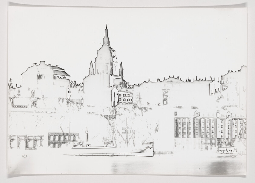 Boats on calm water in front of city skyline dominated by a large cathedral.