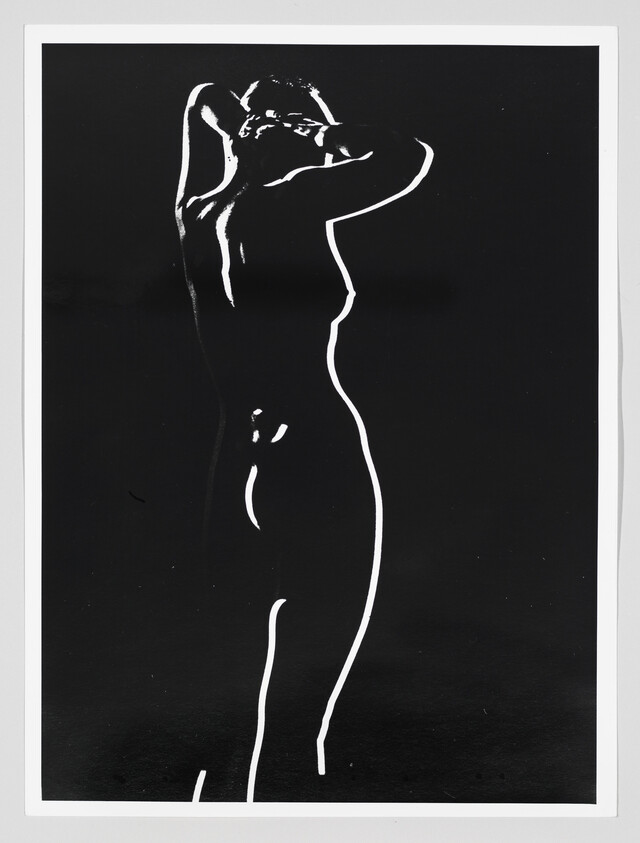 High-contrast black-and-white silhouette of a standing nude woman with her hands behind her head.