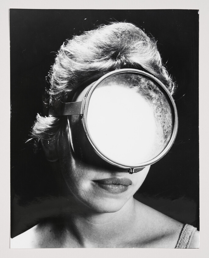 Woman wearing large round goggles that completely cover her eyes, showing only her nose and lips.