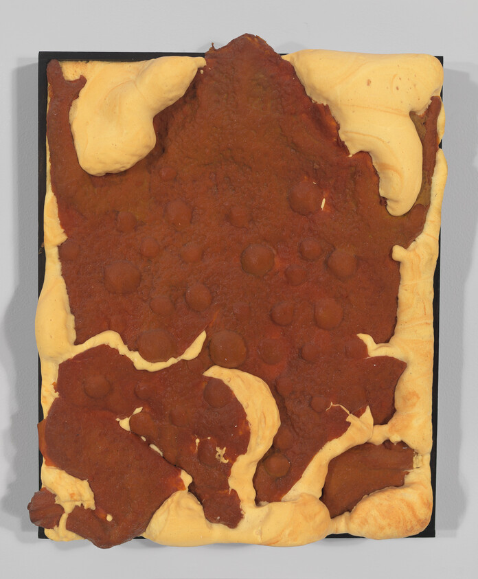 Rectangular artwork with yellow foam edges and a rough brown surface studded with round impressions.
