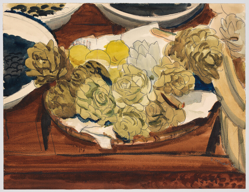 A bowl of green artichokes and yellow lemons resting on a cloth on a wooden table.