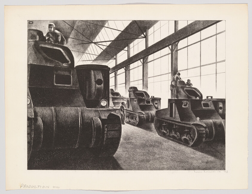 Several armored tanks parked inside a large factory hall with workers inspecting them.