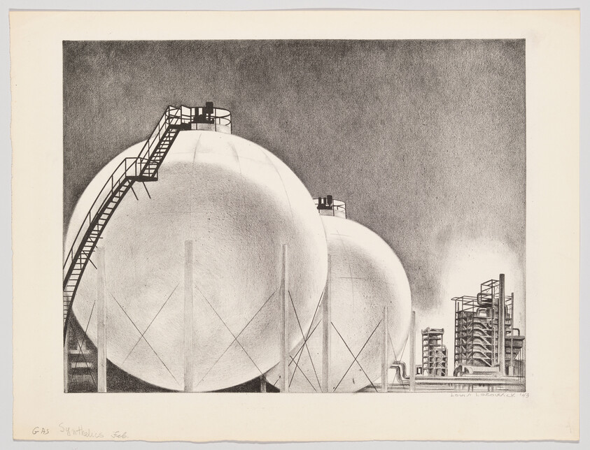 Two large spherical gas storage tanks with external staircases standing beside an industrial processing plant.