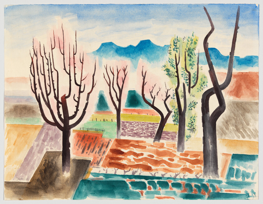 Bare trees stand among colorful terraced fields with distant blue mountains under a pale sky.