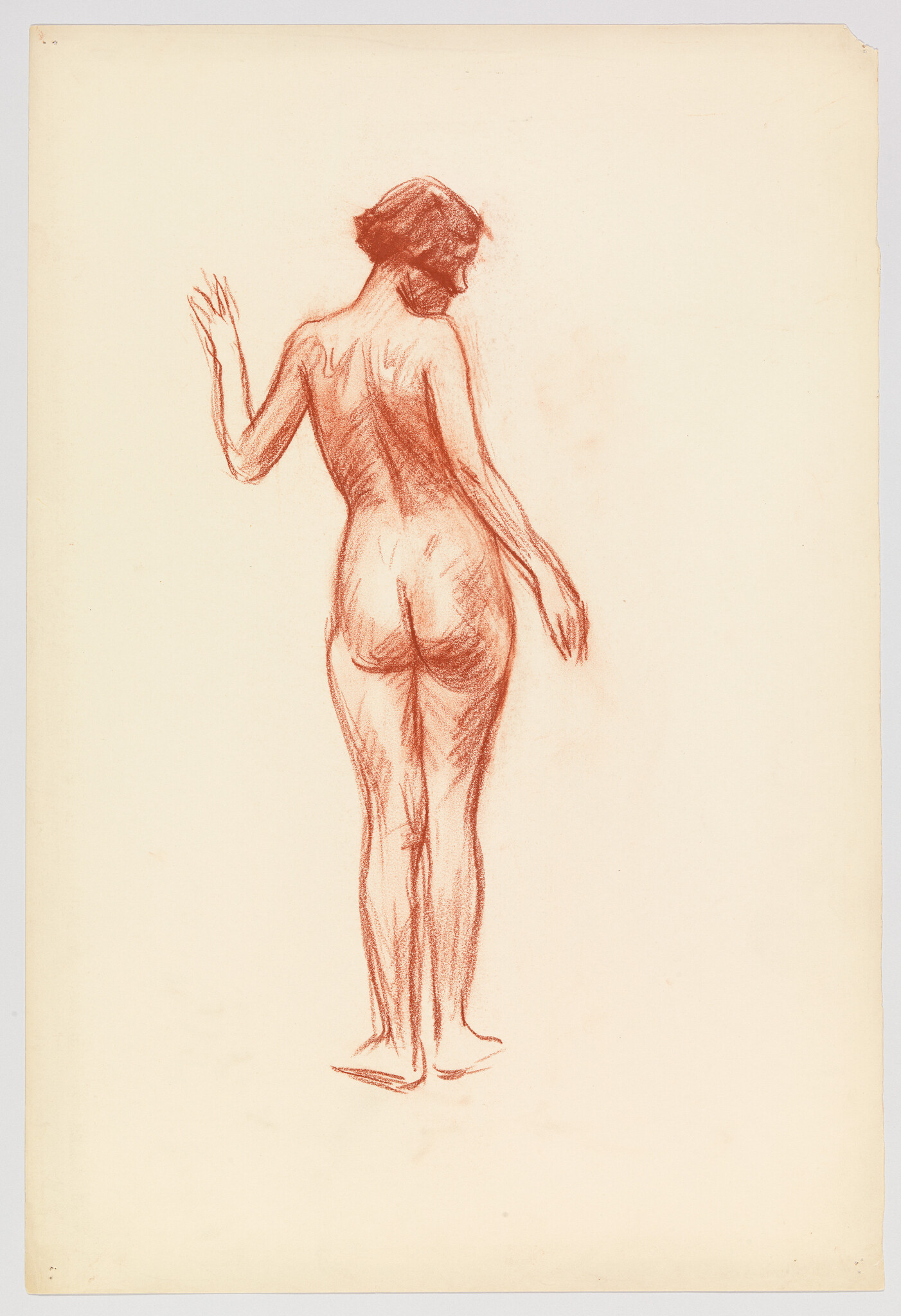 Standing nude woman seen from behind with one arm raised in a red chalk sketch.
