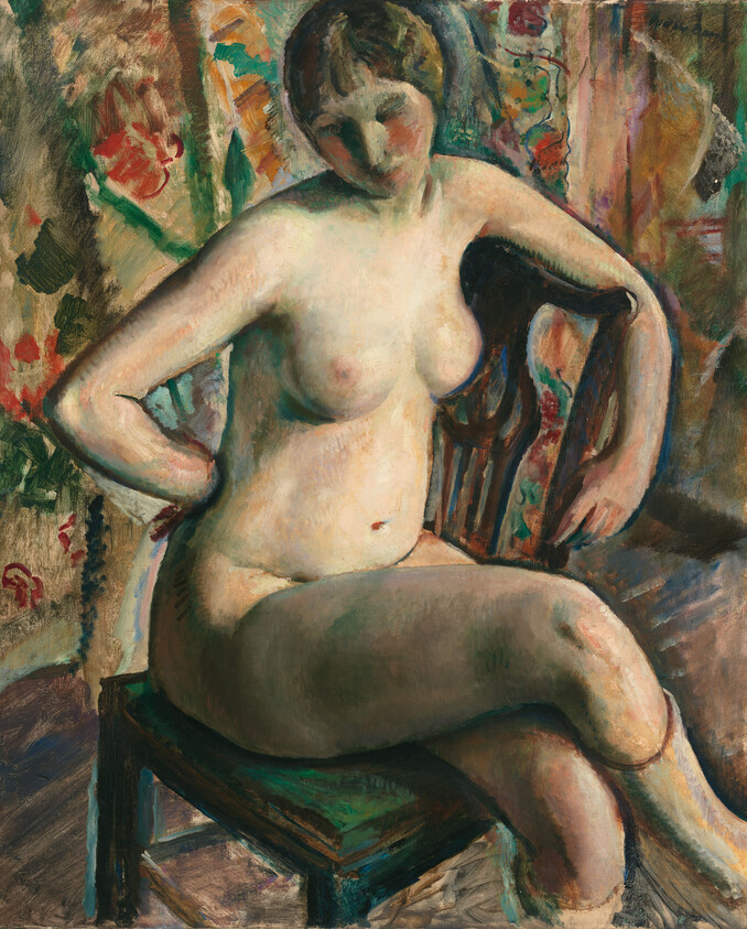 A nude woman sits on a wooden chair with patterned wallpaper behind her.