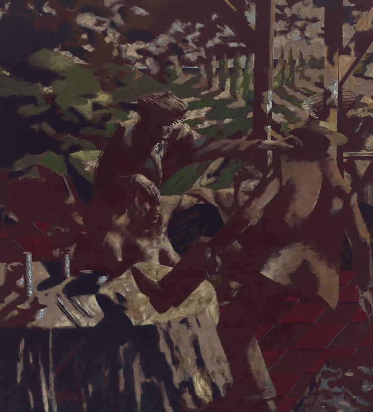 Three people gathered around a table outdoors, one person reaching to touch another's shoulder.