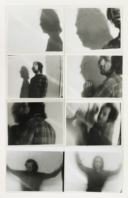 A series of eight black and white Polaroid photos showing various blurry images of a person and their shadow against a wall. The top row features silhouettes, the middle rows show the person looking sideways and directly at the camera, and the bottom row captures the person with arms outstretched.
