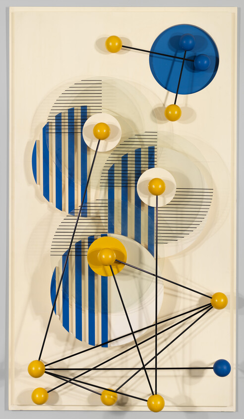 Abstract wall sculpture with blue striped discs and yellow and blue spheres connected by black rods.