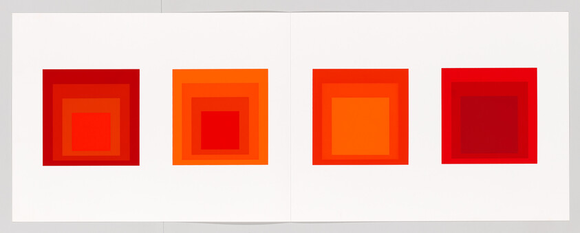 Four nested square color prints in varying red and orange tones arranged side by side on a white spread.