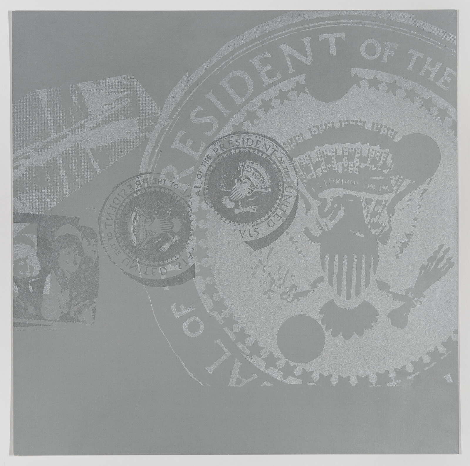 A grayscale image featuring various embossed seals and insignia related to the President of the United States, with the most prominent being the Presidential Seal in the center. The image has a textured appearance with subtle variations in shades of gray, creating a monochromatic and official-looking design.