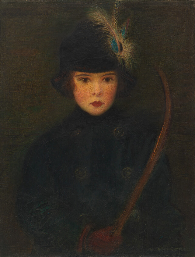 A young child wearing a dark coat and feathered hat holds a curved stick, looking straight ahead.