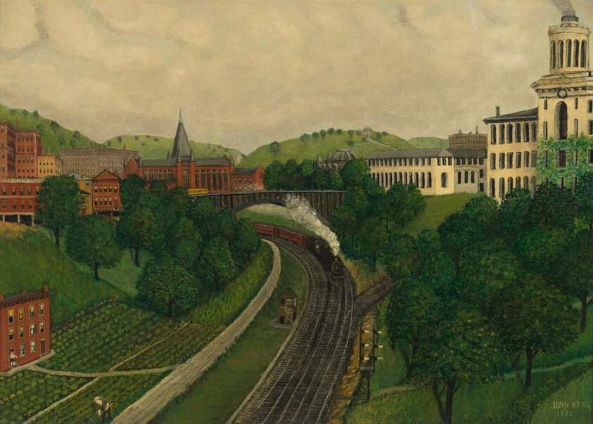 A steam train curves along tracks through a green valley toward a bridge and town.