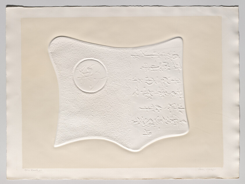 Embossed white abstract shape with a circular seal and raised script on beige paper.