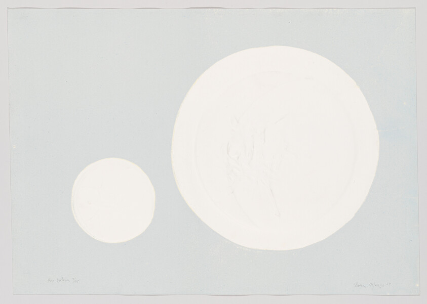 Two white circular shapes sit on a pale blue background, one much larger than the other.