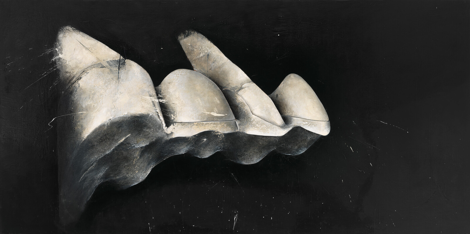 Large sculpted white stone resembling four rounded teeth against a black background.