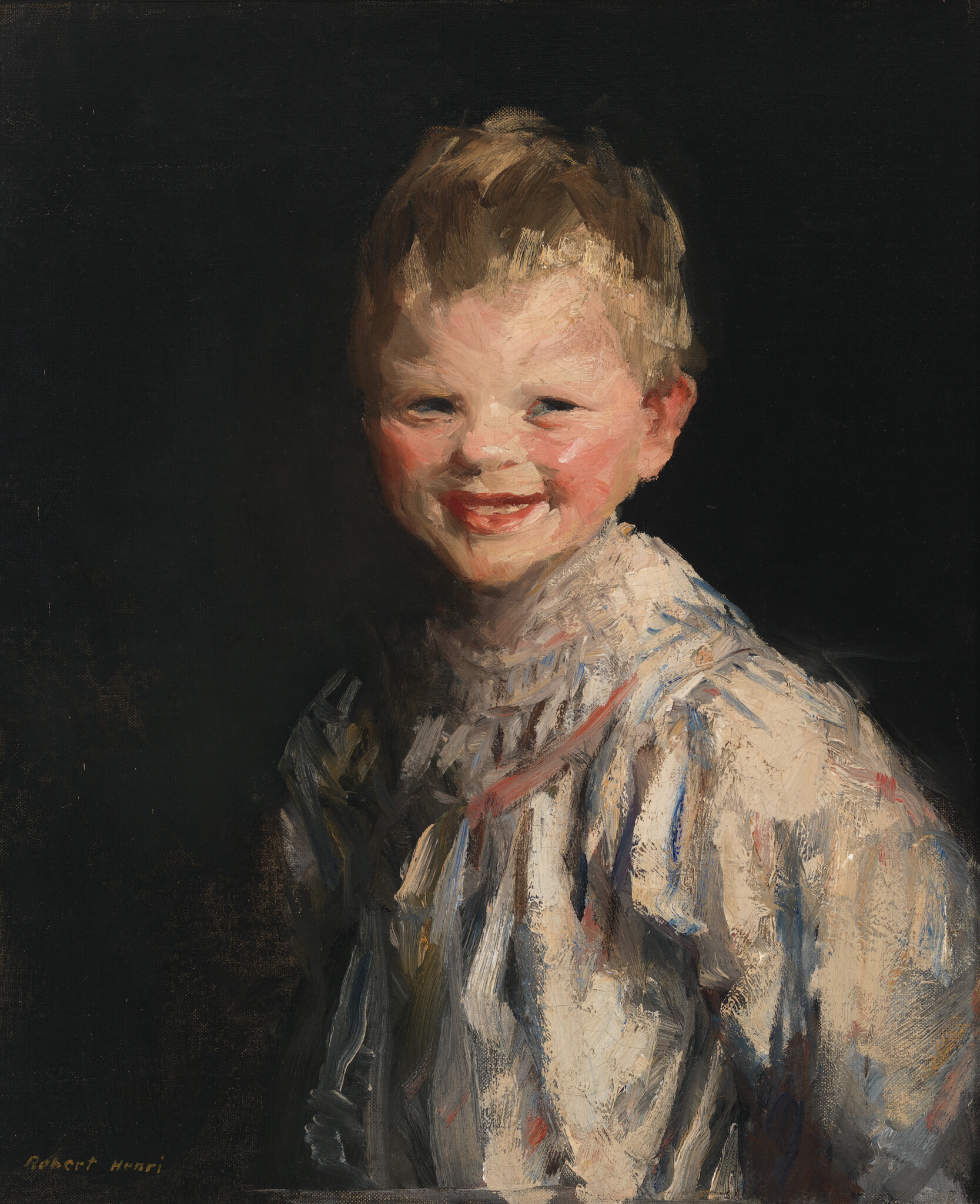 A young smiling boy wearing a loose white shirt looks toward the viewer.