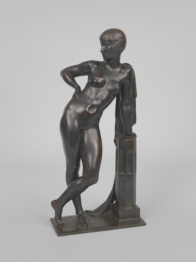 Bronze sculpture of a nude woman leaning on a draped column with hand on hip.