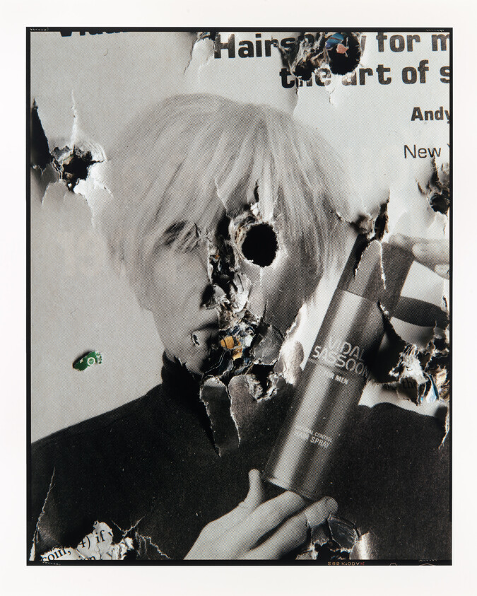 Poster of a person with bleached hair holding a hairspray can, torn and burned in several places.