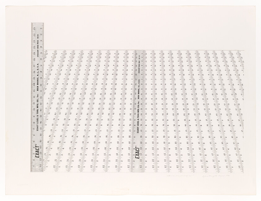Two metal rulers arranged in an L over a grid of repeating measurement markings.