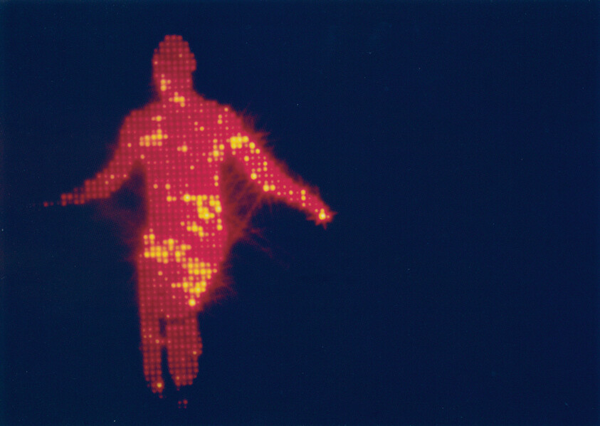 A glowing red pixelated human silhouette with bright yellow hotspots floats against a dark blue background.
