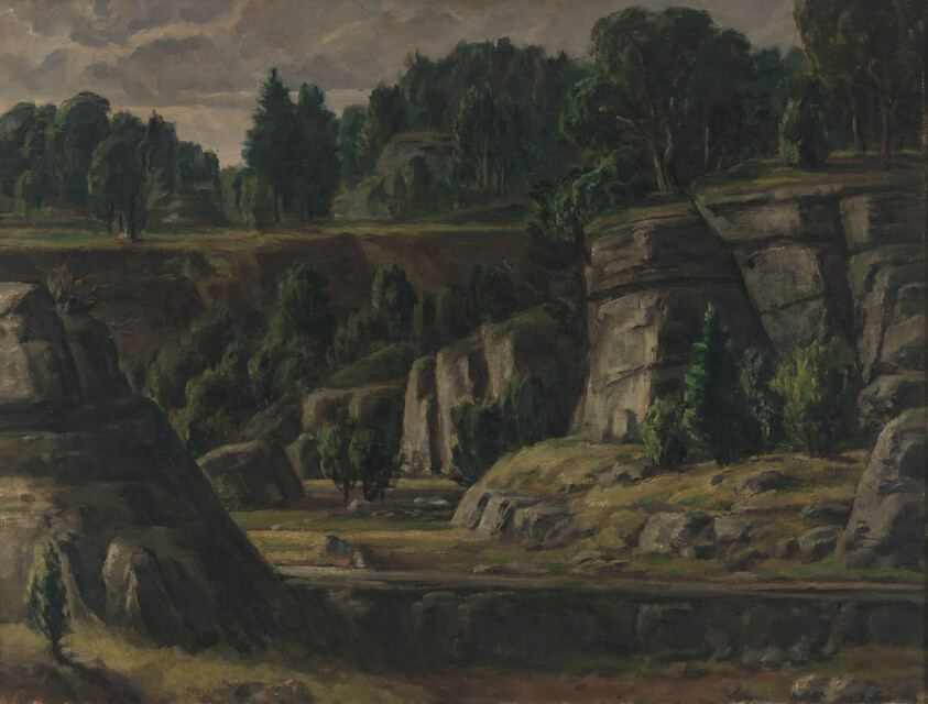 Rocky canyon with steep cliffs, scattered trees, and a calm river running through the valley.