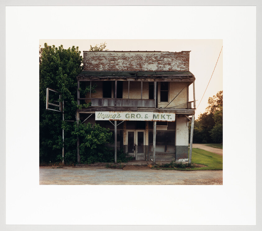 Old two-story grocery and market storefront sits abandoned with faded Young's Gro. & Mkt. sign.