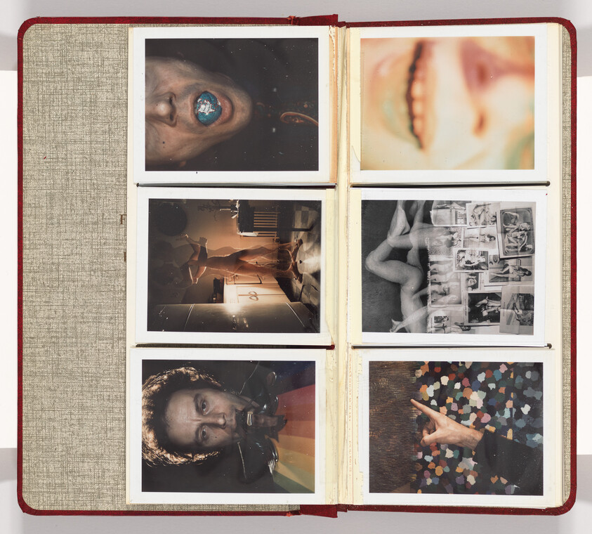 Opened red photo album showing six vintage Polaroids of faces, figures, and a pointing hand.