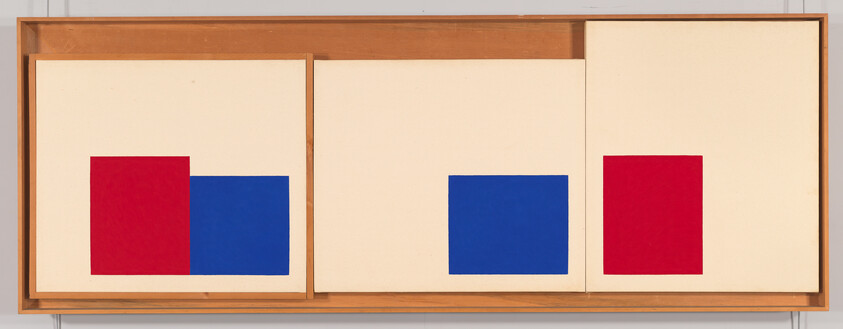 Three-panel minimalist artwork with red and blue squares on cream panels framed in wood.