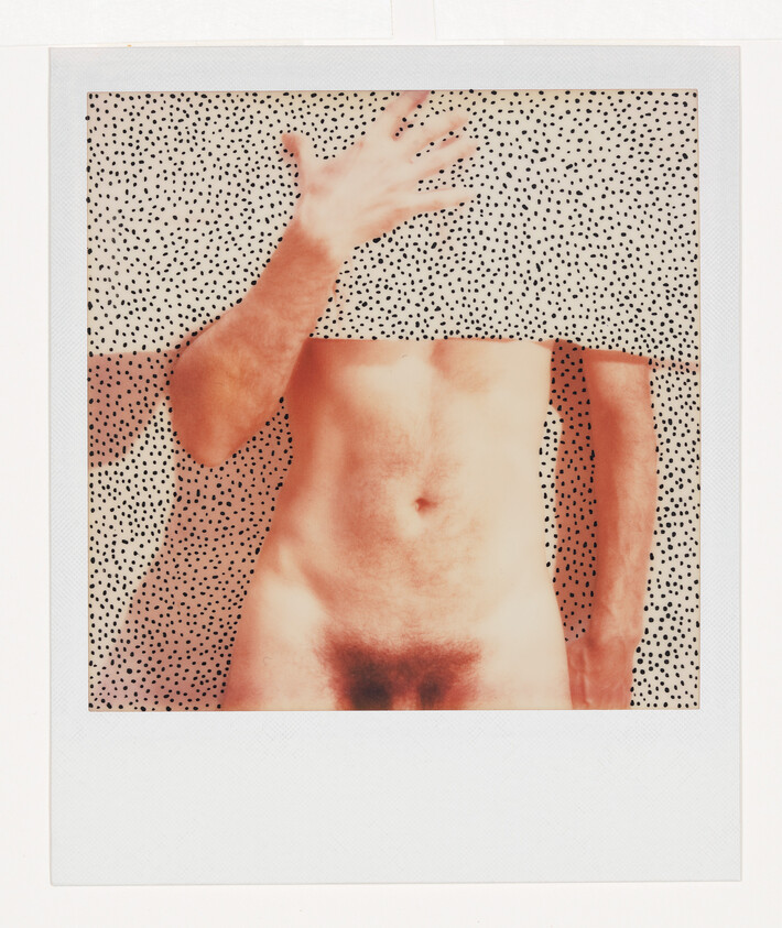 A bare torso with one hand lifting a polka-dot cloth that hides the head.