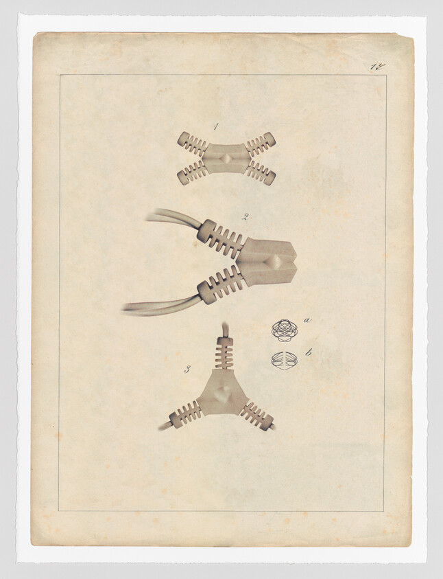 Vintage illustration of various mechanical parts, possibly from a patent application, displayed against an aged paper background. The parts include a central hexagonal piece with multiple connectors and several separate components that appear to interlock with the central piece.