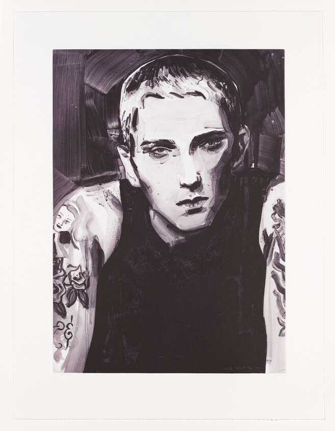 Young person with short hair and tattooed arms stares directly with a serious expression.