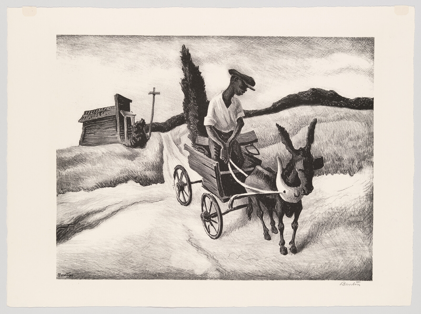 A man steers a small donkey-drawn cart down a dusty country road past a shack.