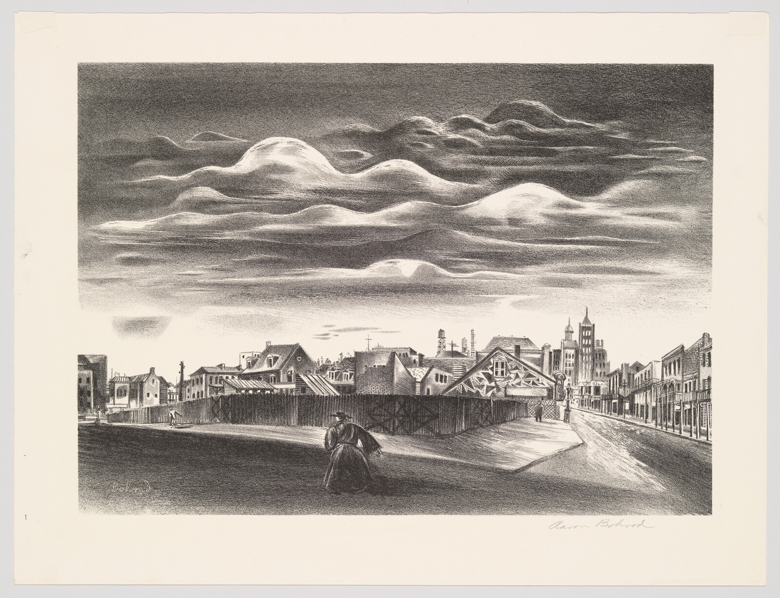 A lone figure walks toward a fenced construction area under dramatic low-hanging clouds above a town.